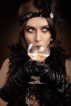 33260249 - portrait of a flapper girl at a party drinking champagne